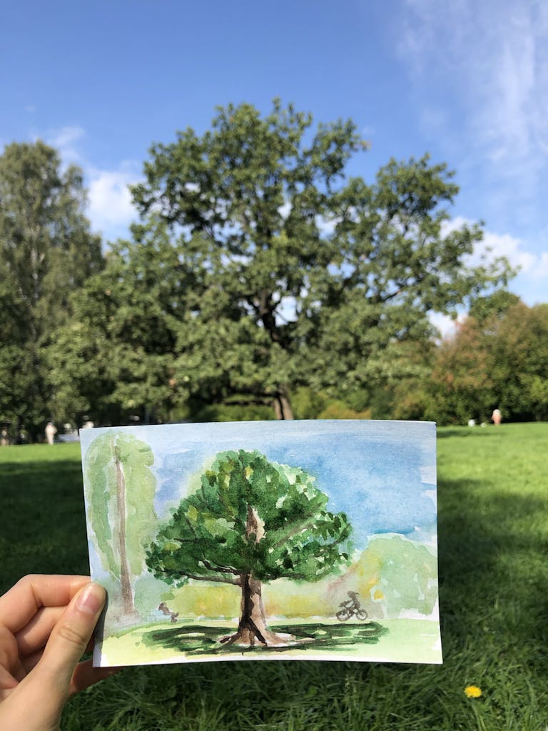 Person Holding a Painting of a Tree